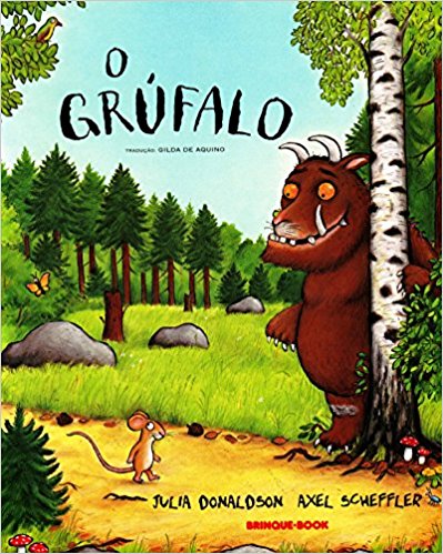 Capa do livro "O Grúfalo", de Julia Donaldson e Axel Scheffler, com ilustração de um animal com chifres, que está em um bosque e olha para um camundongo, que está no chão. 