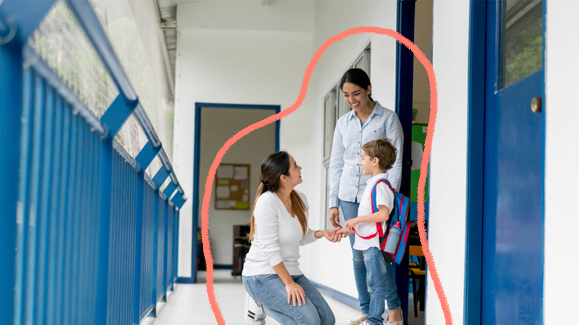 Duas mulheres conversando com um menino no corredor de uma escola