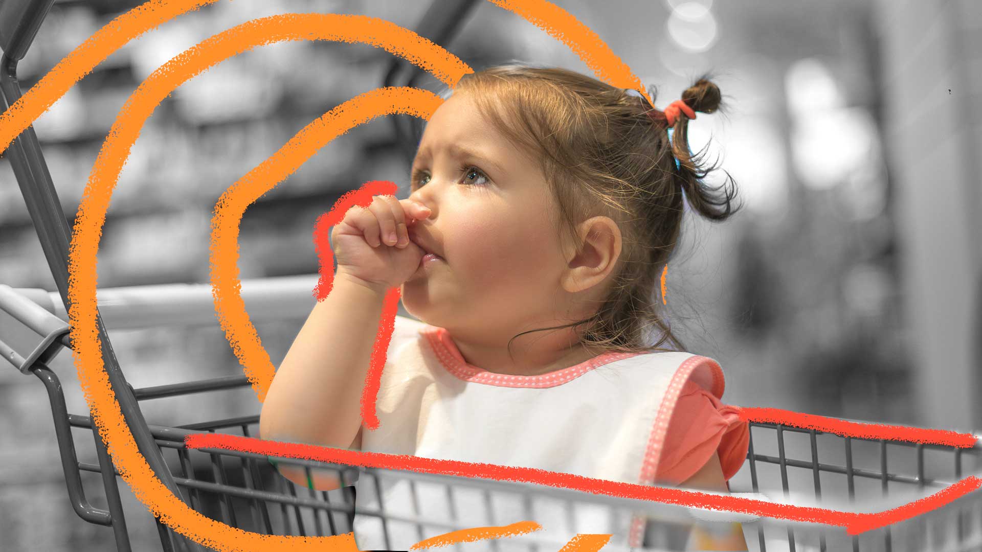 Chupar o dedo: foto em preto e branco, no centro um bebe está dentro de um carrinho de supermercado, chupando o dedo da mão esquerda.