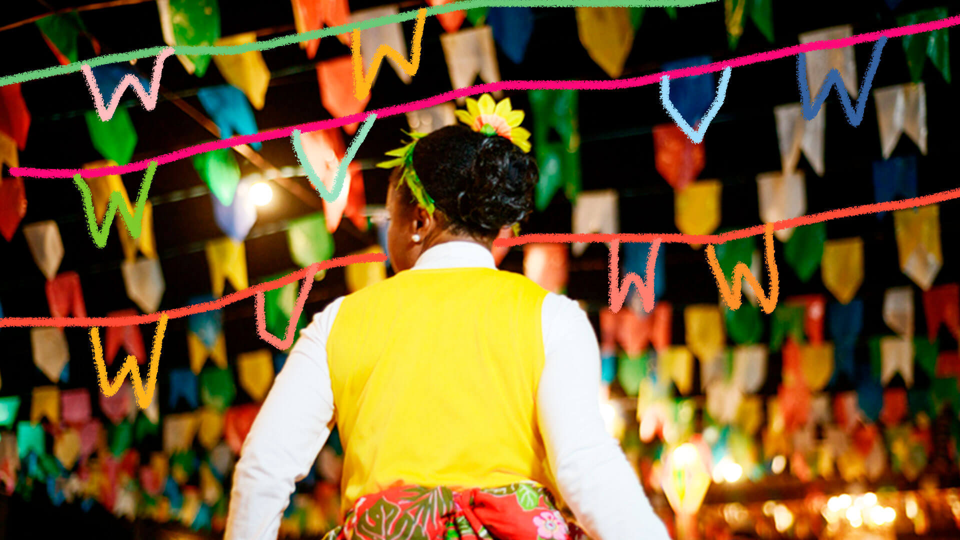 Criança de costas em uma festa junina, cheia de bandeirolas coloridas
