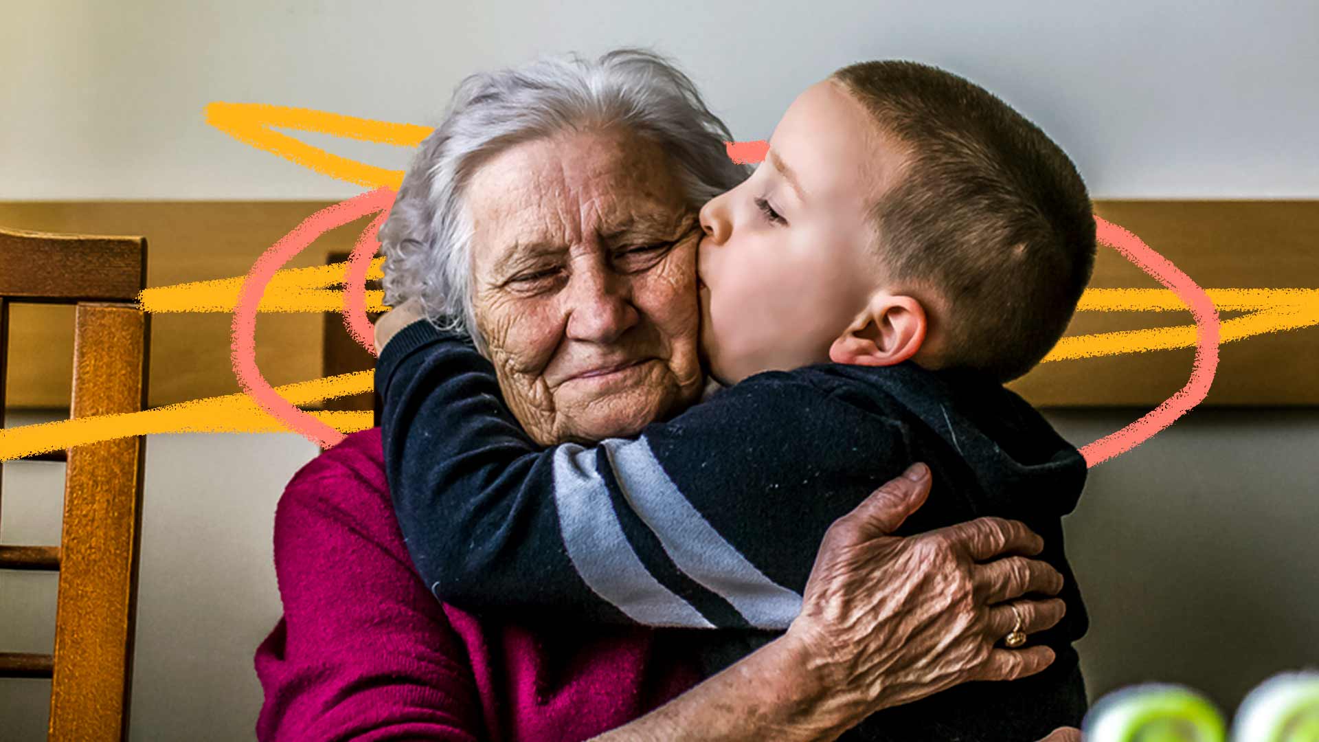 Músicas sobre avós: um menino beija a avó no rosto, uma senhora de cabelos grisalhos. Ambos vestem blusas de manga comprida.
