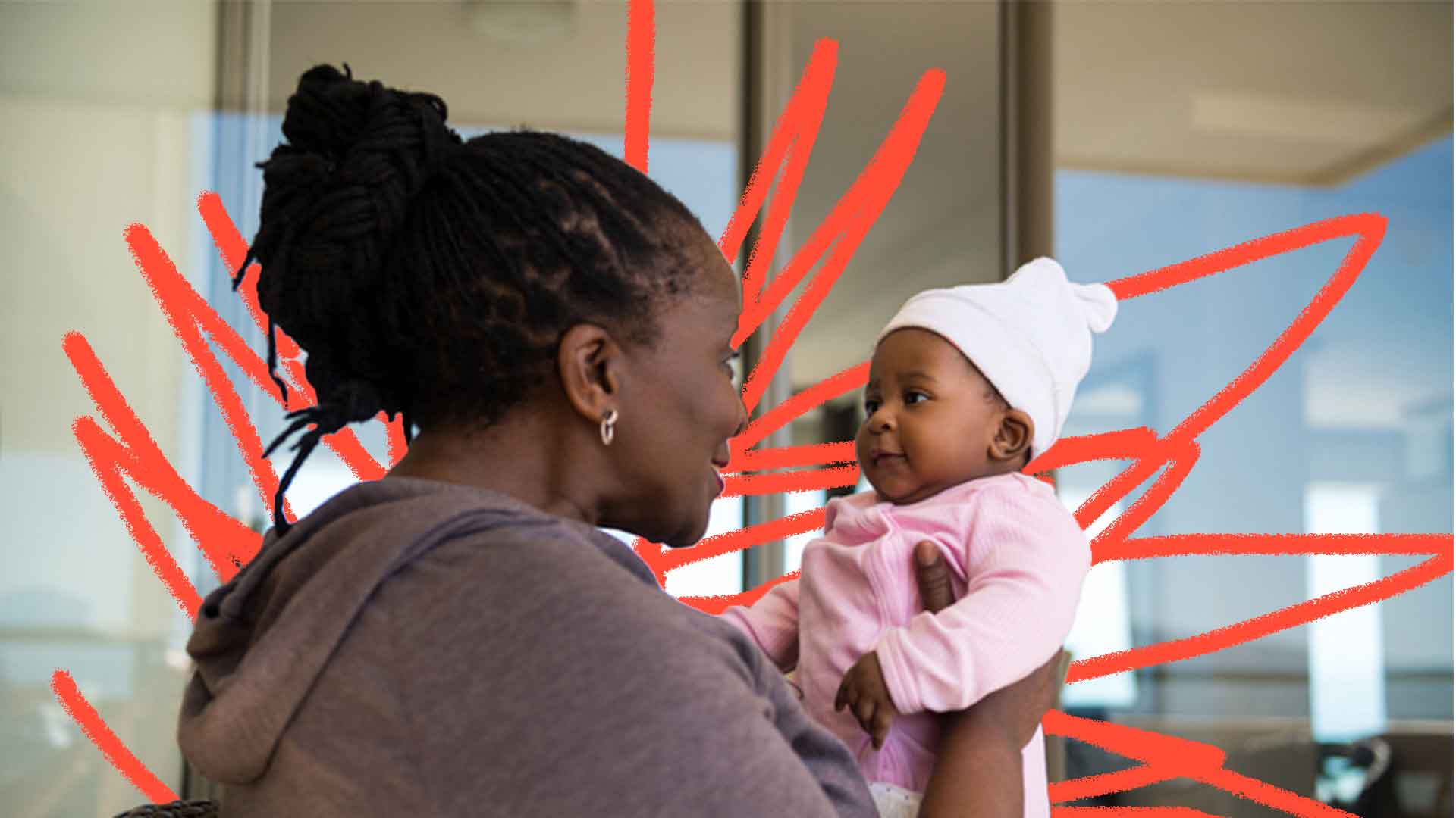 Imagem de uma mulher negra segura uma bebê de touca enquanto olha em seus olhos