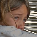 Foto de uma menina olhando fixamente. Aparece apenas seus olhos com lágrimas. Artigo sobre desigualdade e pandemia.