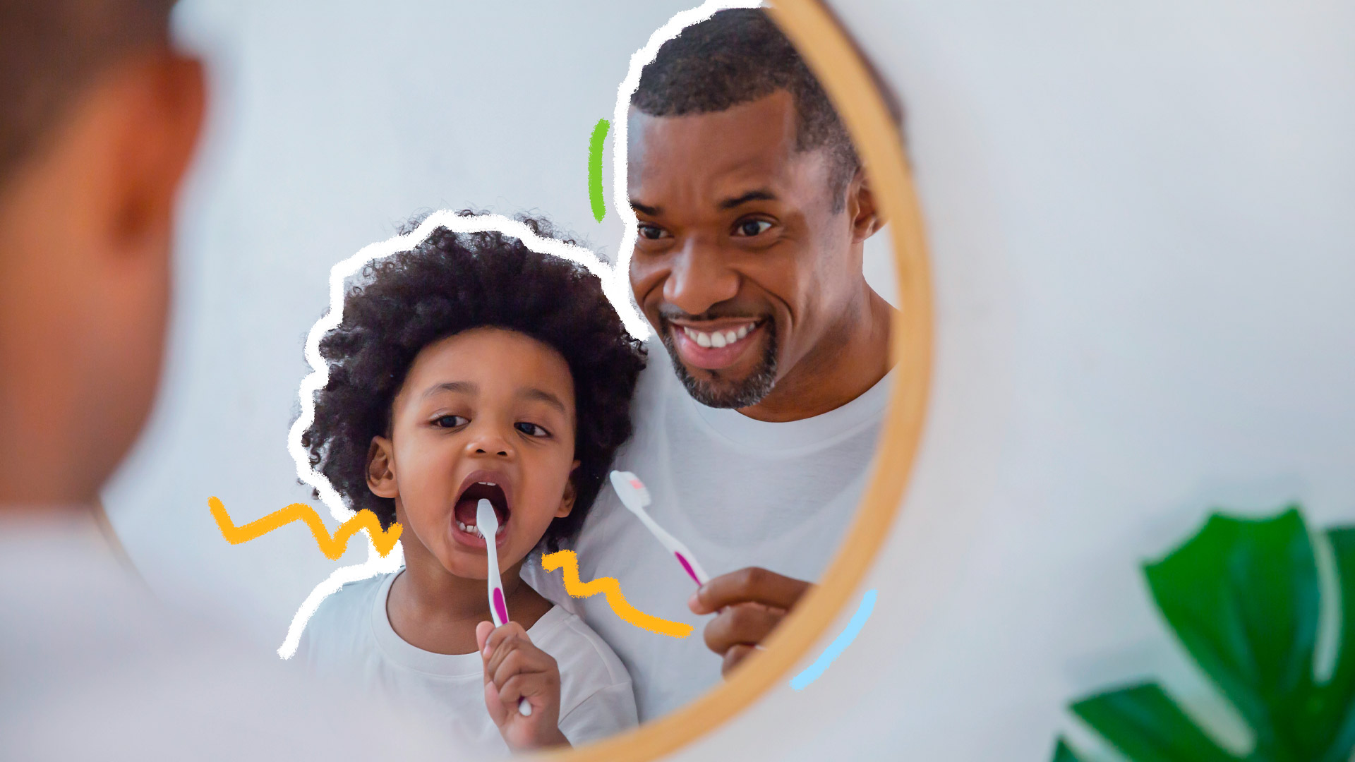 Foto de pai e filho, ambos negros e vestindo uma camiseta branca, em frente ao espelho: o pai ensina o filho, que está escovando os dentes