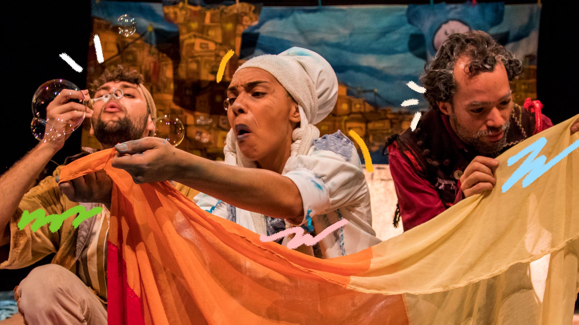 Atores da peça Os Lavadores de Histórias sopram bolhas de sabão durante performance teatral