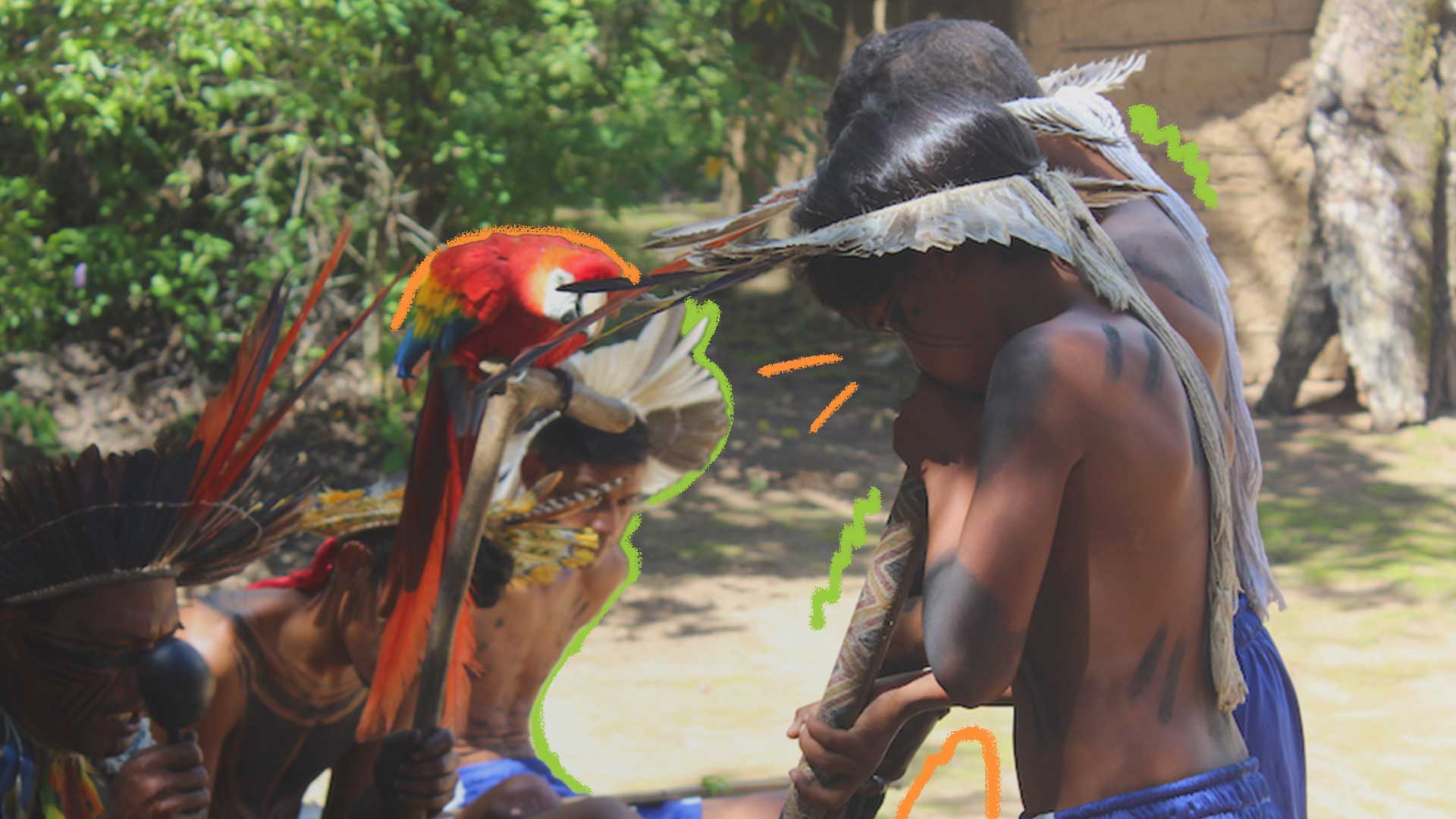 Foto de um menino indígena assoprando um instrumento de madeira, usando cocar. À sua frente, estão outros indígenas adultos