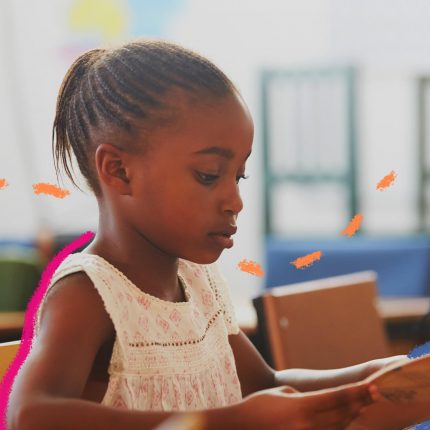 Foto de uma menina negra haitiana, estudando em uma sala de aula