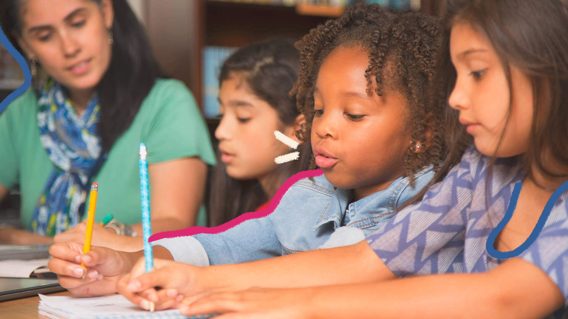 Uma turma de alunas participa de uma aula. Em destaque, uma menina negra escreve com um lápis em uma folha em branco.