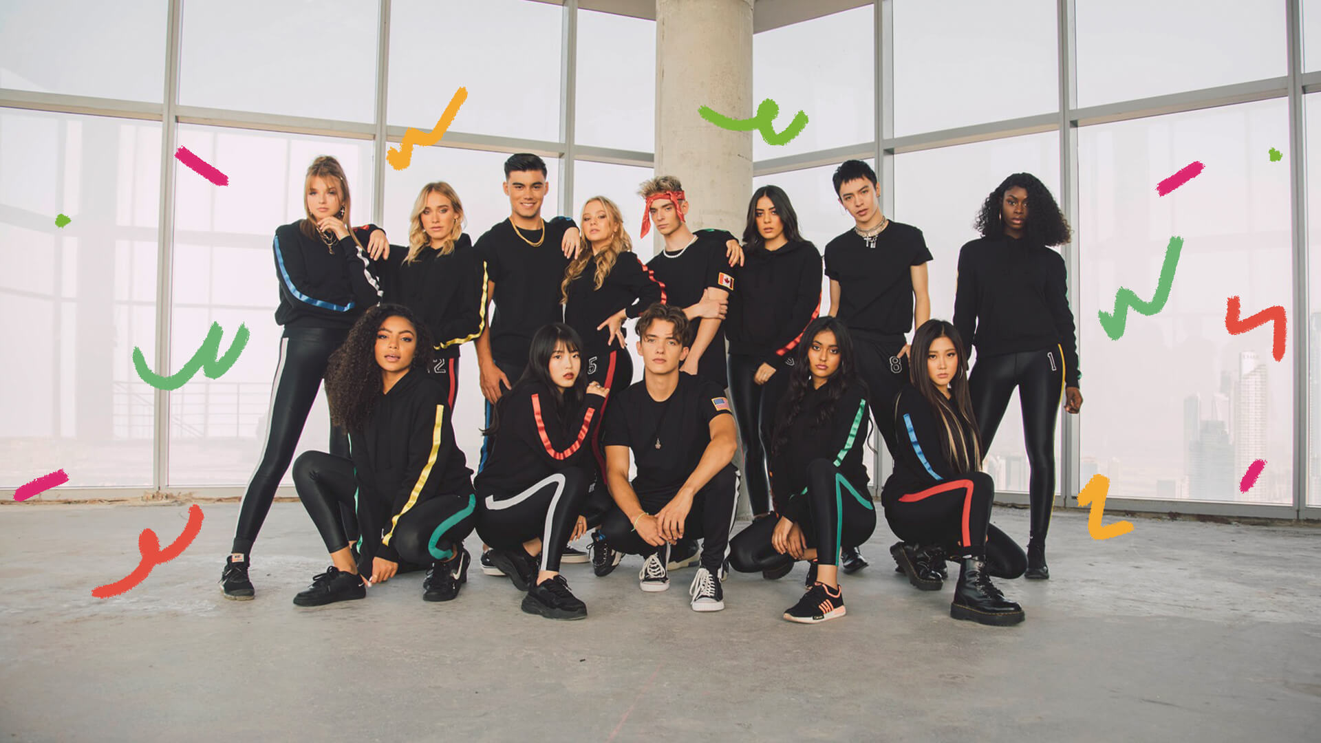 Foto do grupo musical Now United. A imagem mostra um grupo multiétnico de jovens.