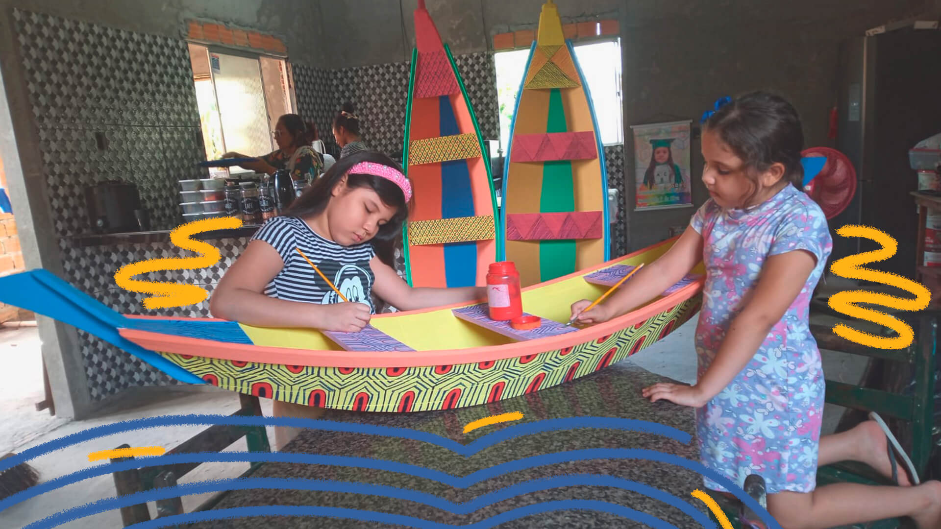 Foto de duas crianças pintando uma embarcação feita de miriti