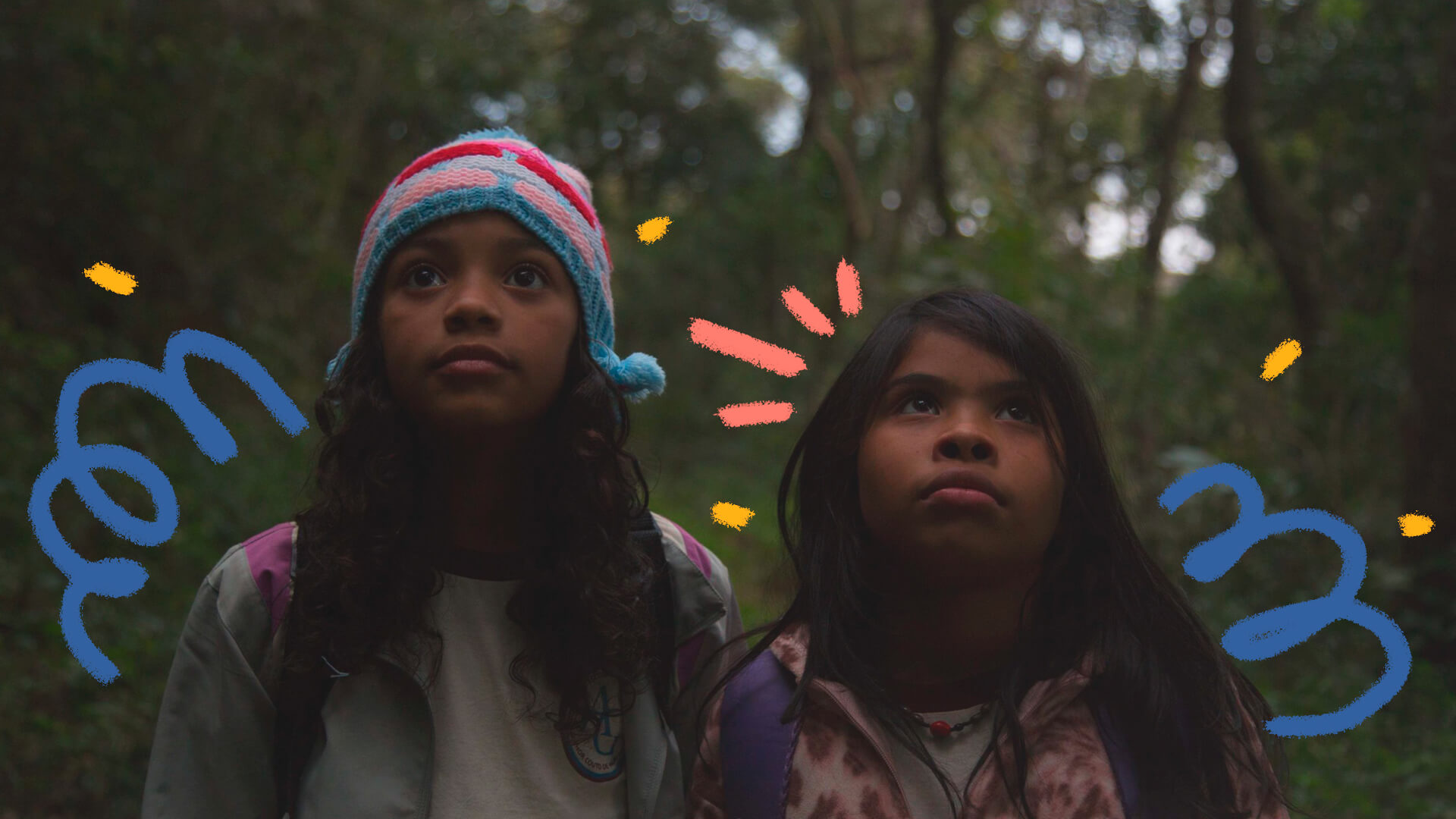 Foto de duas meninas indígenas na floresta, olhando para cima. A imagem é do filme “Para’í” (2018), de Vinicius Toro, e ilustra matéria sobre a Ciranda de Filmes 2023.