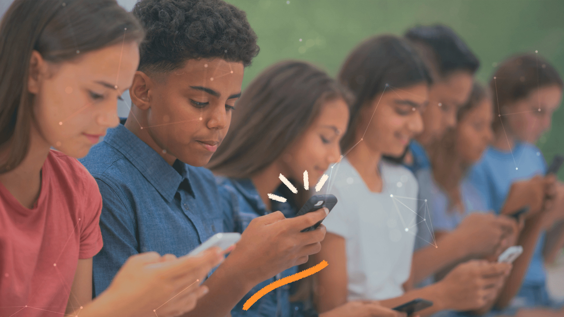 Um grupo de crianças estão sentados lado a lado e cada um olha para uma tela de celular
