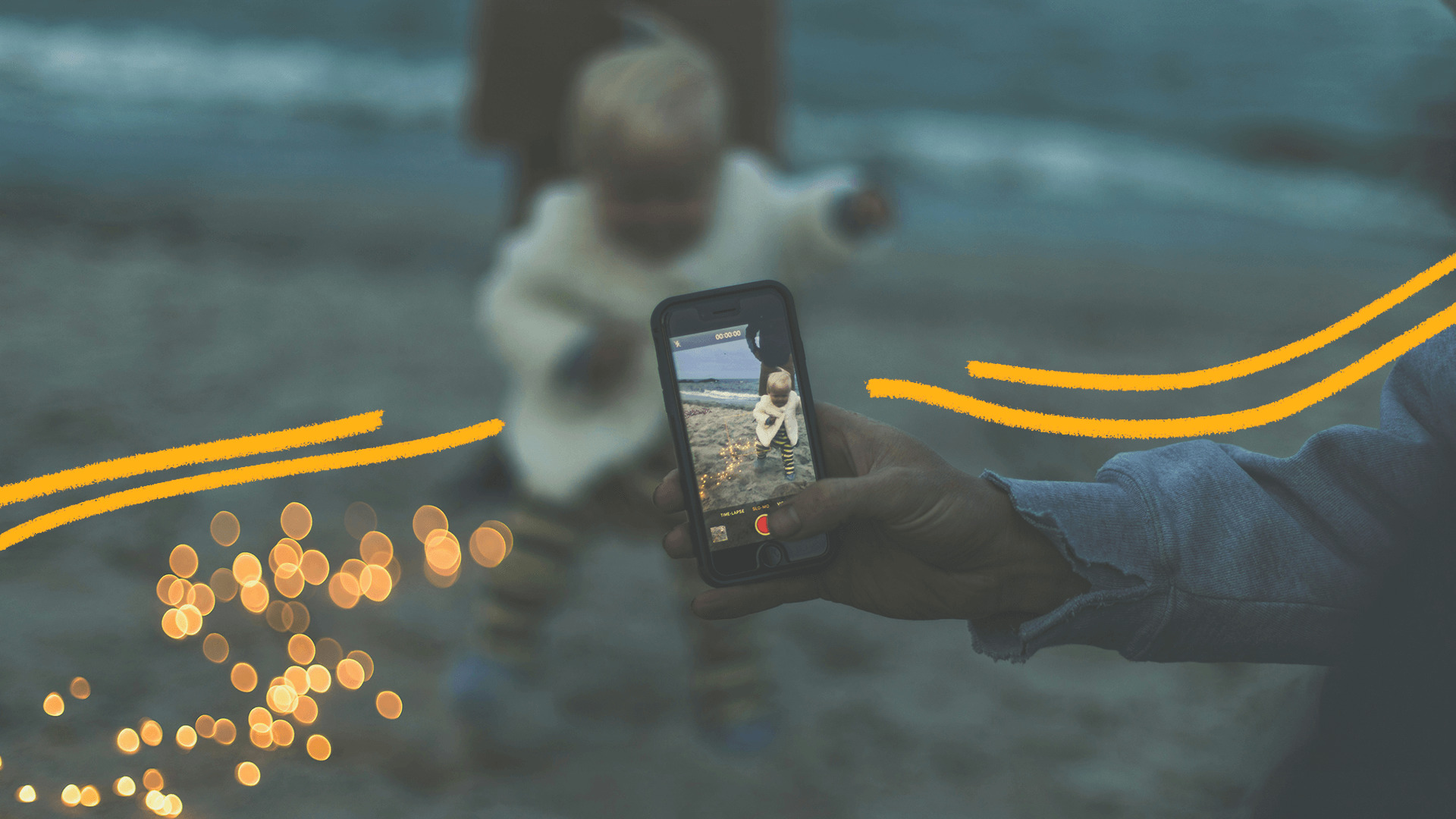 Imagem de capa para matéria sobre sharenting mostra uma mão de um aduto segurando um celular com a câmera apontada para um bebe em uma praia.