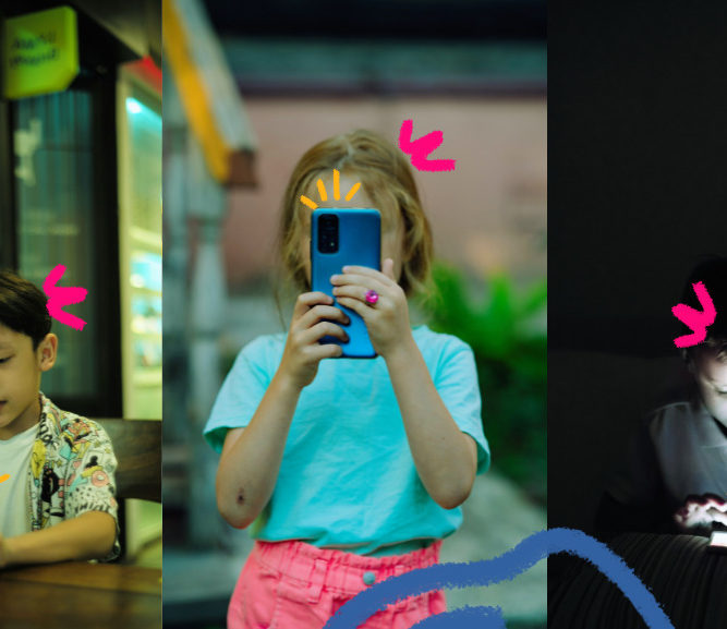 Imagem mostra três crianças usando celulares . Uma menina ao cntro e dois meninos nas pontas.