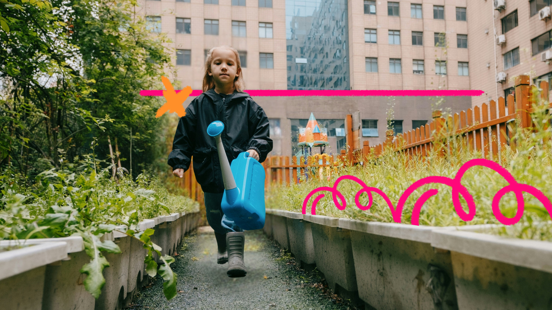 Criança caminha por um canteiro verde em área urbana, segurando um regador azul, entre plantas e cercas de madeira, com prédios ao fundo, em um espaço que mistura natureza e cidade.